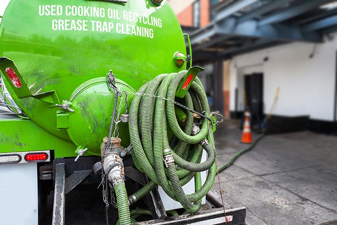 a vacuum truck pumping out a large underground grease trap in Farmingdale, NY